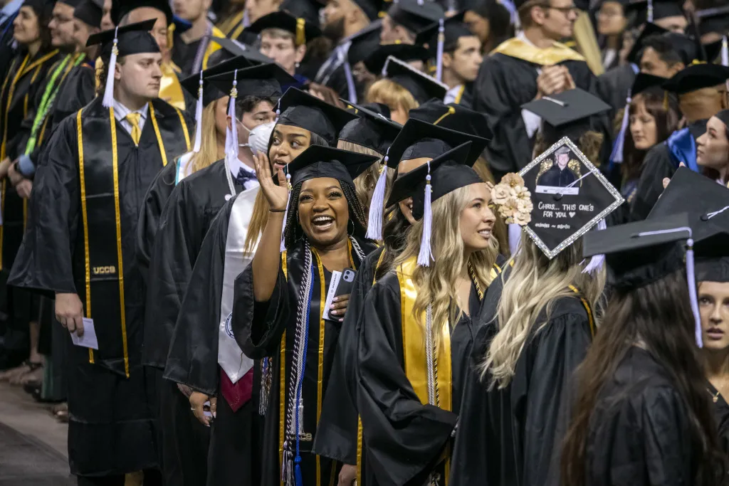 students smiling at graduation ceremony